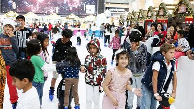 Children enjoy the artificial snow at the Snow and Winter Wonderland at the ice rink at Dubai Mall. Pawan Singh / The National