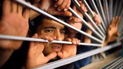 Palestinians look at the body of Palestinian Mousab Al-Zaanin through the window of a hospital morgue in the northern Gaza Strip. Mohammed Salem / Reuters