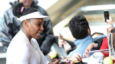 Serena Williams signs a Maori doll after her first round win against Camila Giorgi. Getty Images