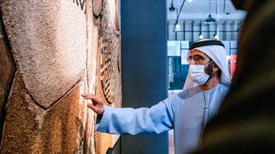 Sheikh Mohammed bin Rashid, Vice President and Ruler of Dubai, examines an exhibit.
