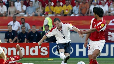 England's Wayne Rooney, centre, scores his second goal of the match as Switzerland's Murat Yakin (5) and Ricardo Cabanas defend during their Euro 2004 Group B match at the Cidade de Coimbra Stadium, in Coimbra, Portugal, Thursday, June 17, 2004. Michael Probst / AP Photo