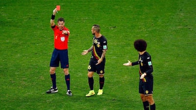 Steven Defour of Belgium is shown a red card by referee Ben Willians as Marouane Fellaini joins in protest on Thursday in their match against South Korea at the 2014 World Cup. Matthew Lewis / Getty Images