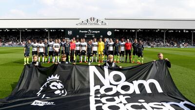 Fulham and Manchester City players stand with the match officials in protest against racism prior to the match. Getty Images