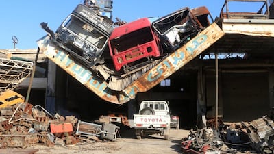 Damaged vehicles are seen piled on a collapsed roof of car mechanic service center southwest of Aleppo, Syria. Abdalrhman Ismail / Reuters