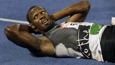 Usain Bolt gets his right hamstring stretched out after losing to Yohan Blake in the 200m.