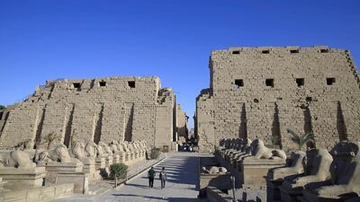 Tourist look out at the ruins of the Karnak Temple in Luxor, Egypt. Foreign tourism, a major part of Egypt’s economy, has been hurt during years of turmoil following the 2011 revolt that saw Hosni Mubarak step down. Hassan Ammar / AP Photo