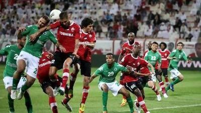 Al Ahli, in red, defend a ball into their penalty area as Al Shabab go on the attack in Dubai last night.