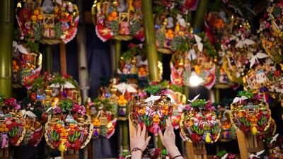 A worker displays various "good luck rakes" during a festival in Tokyo. Eugene Hoshiko / Reuters