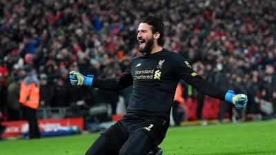 Alisson Becker slides on his knees after sprinting the length of the pitch. Getty Images