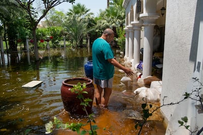 Rubesh Pillai inspects floodwaters at his home in Green Community West in Dubai in April 2024. Antonie Robertson / The National