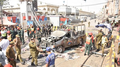 Officials examine the site of the bomb blast. EPA