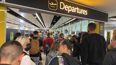Passengers queue at Gatwick Airport on June 7, 2022. The airport has announced a limit on travellers this summer. PA