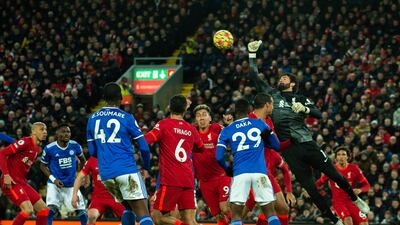 Liverpool goalkeeper Alisson Becker punches clear. EPA
