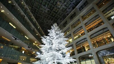 A Christmas tree stands on display in a shopping mall in Tokyo. Retailers go the extra mile to make their illumination displays more attractive to shoppers. Kiyoshi Ota / Bloomberg