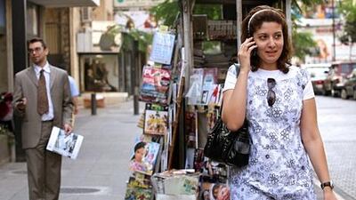 A woman speaks on a mobile phone in Beirut. Lebanon is looking at a new telecoms model. Joseph Barrak / AFP