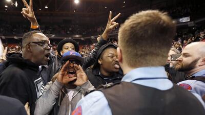 Protesters against Republican presidential candidate Donald Trump shout at his supporters after it was announced that a rally for the business tycoon had been cancelled due to security concerns on the campus of the University of Illinois-Chicago. Charles Rex Arbogast/AP Photo