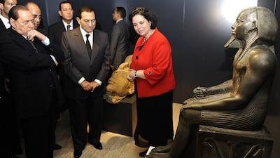 Egyptian President Hosni Mubarak, Mr Berlusconi, left, and director of the Egyptian Museum in Cairo Wafaa Elsaddik visit the Egyptian Academy in Rome, in September 2010. AFP