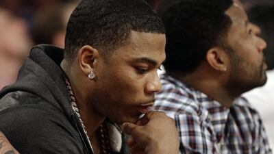Rapper Nelly sits near the court during the skills competition. Gerald Herbert / AP photo