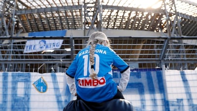 A girl wearing a Diego Maradona shirt is seen outside the Stadio San Paolo in Naples. Reuters