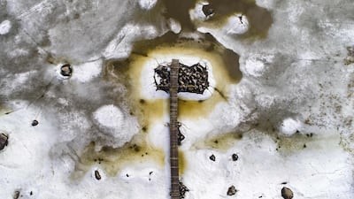 A wooden jetty is surrounded by melting sea ice in the islands of Merenkurkku Archipelago, near Vaasa, western Finland, at the beginning of spring. Olivier Morin / AFP