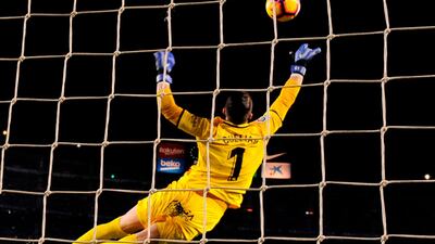 Leganes goalkeeper Pichu Cuellar makes an acrobatic save against Barcelona. AFP