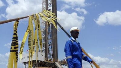 An engineer walks past an oil rig at the Ngamia-1 well in the Lokichar basin, which is part of the East African Rift System in Kenya. Njuwa Maina / Reuters