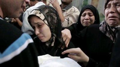 The parents of 11-month-old Palestinian baby Omar Misharawi, killed in an Israeli strike, hold his body during his funeral in Gaza City.