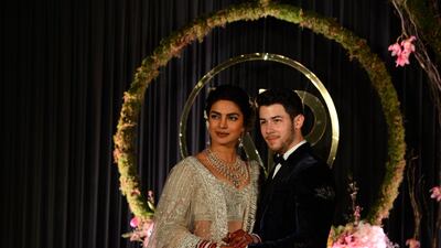 Newlyweds Priyanka Chopra, 36, and Nick Jonas, 26, pose for a photograph during a reception at a hotel in New Delhi on December 4, 2018. Photo: AFP
