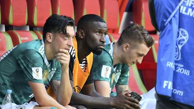 Germany midfielder Mesut Ozil, left, defender Antonio Ruediger and forward Marco Reus watch as their team loses 3-0 to South Korea in their World Cup match on June 27, 2018. AFP