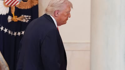 US President Donald Trump leaves the Cross Hall of the White House after his address to the nation. AFP