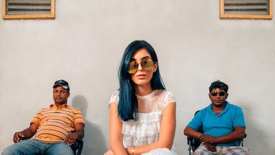 An influencer’s photoshoot in Satwa in which a scantly clad-model poses with Satwa men in the background has caused controversy and debate. Photo Courtesy Waleed Shah