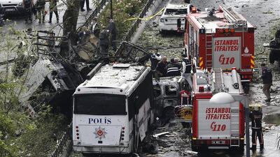 Police officers inspect the area after a bomb attack on a police bus during rush-hour traffic in Istanbul killed 11 people. Sedat Suna / EPA