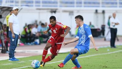 The UAE's Mohammed Fawzi, left, in action during their 1-0 win over Uzbekistan in Al Ain. Image courtesy of UAE FA.