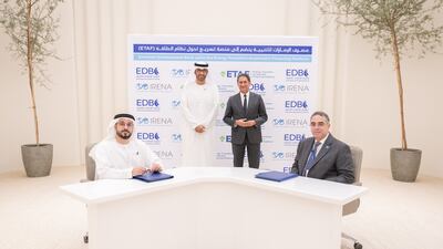 Dr Sultan Al Jaber, Cop28 President-designate, and Irena director general Francesco La Camera witness the signing of a partnership agreement between Emirates Development Bank's Ahmed Al Naqbi, left, and Irena's Ahmed Badr. Photo: EDB