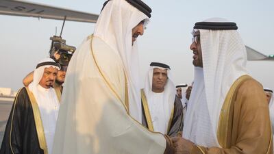 Sheikh Mohammed bin Zayed greets Sheikh Tamim bin Hamad Al Thani Emir of Qatar (L) upon arrival at Qatar. Seen with Sheikh Saud bin Saqr Al Qasimi, Supreme Council Member and Ruler of Ras Al Khaimah and Sheikh Humaid bin Rashid. Mohamed Al Hammadi / Crown Prince Court - Abu Dhabi