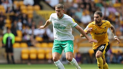 Newcastle defender Sven Botman under pressure from Ruben Neves of Wolves. Getty