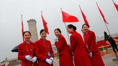 Ushers pose for pictures outside of Beijing's Great Hall of the People before the opening session of the 19th National Congress of the Communist Party of China. Tyrone Siu / Reuters