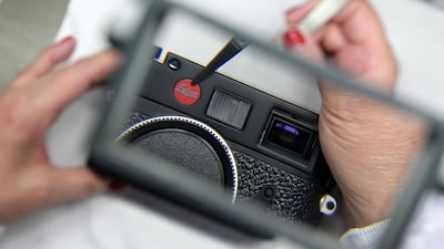 A mechanic fixes the Leica logo to an M9 camera at the production facility of Leica in Solms, western Germany. Daniel Roland / AFP