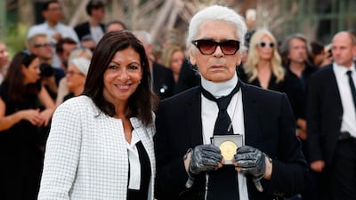 Paris's mayor Anne Hidalgo awards the Grand Vermeil De La Ville De Paris medal to German fashion designer Karl Lagerfeld after Chanel's haute couture autumn/winter 2017-18 show in Paris on July 4. Patrick Kovarik / AFP