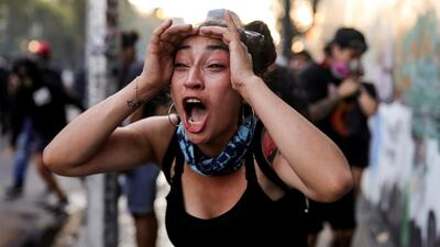 A demonstrator reacts during a protest against Chile's government in Santiago, Chile. Reuters