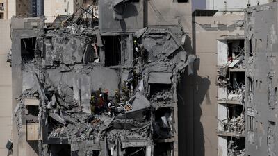 Israeli rescue teams search for survivors amid the rubble of residential buildings destroyed by an Iranian missile in Beersheba. Reuters