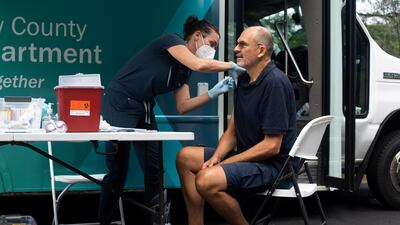 Nurse Elizabeth Head inoculates Ingobert Schamdel with a Covid-19 vaccine in Ypsilanti, Michigan, on Saturday. Reuters