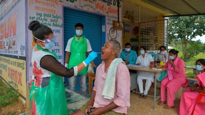 A health official collects a swab sample from a man to test for the coronavirus at a village on the outskirts of Bengaluru in south India. AFP