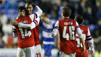 Arsenal's Theo Wallcott is congratulated by Marouane Chamakh after his last-gasp winner against Reading