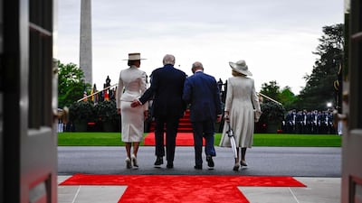 Mr Trump, Ms Trump, King Charles and Queen Camilla walk together. AFP