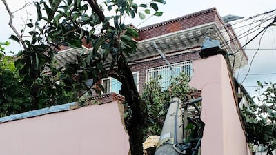 An electric pole falls down in Ulsan. AFP