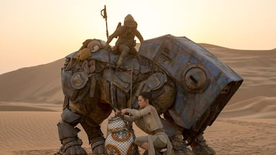Star Wars: The Force Awakens showing BB-8 with Rey (Daisy Ridley) David James / Lucasfilm / Disney