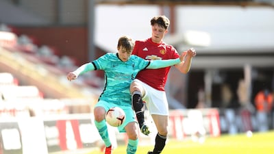 Liverpool's Max Woltman battles for possession with Will Fish of Manchester United. Getty Images