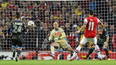 Mesut Ozil, right, scores Arsenal’s first goal past Pepe Reina, the Napoli goalkeeper, at Emirates Stadium on Tuesday night. The Germany international also created the second for Olivier Giroud. Gerry Penny / EPA