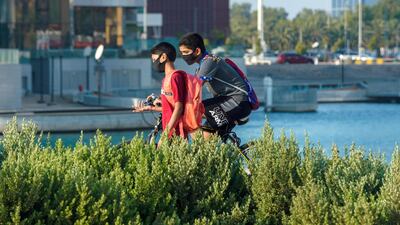 People walk along near the Ramada Hotel Abu Dhabi Corniche during the pandemic. Victor Besa / The National